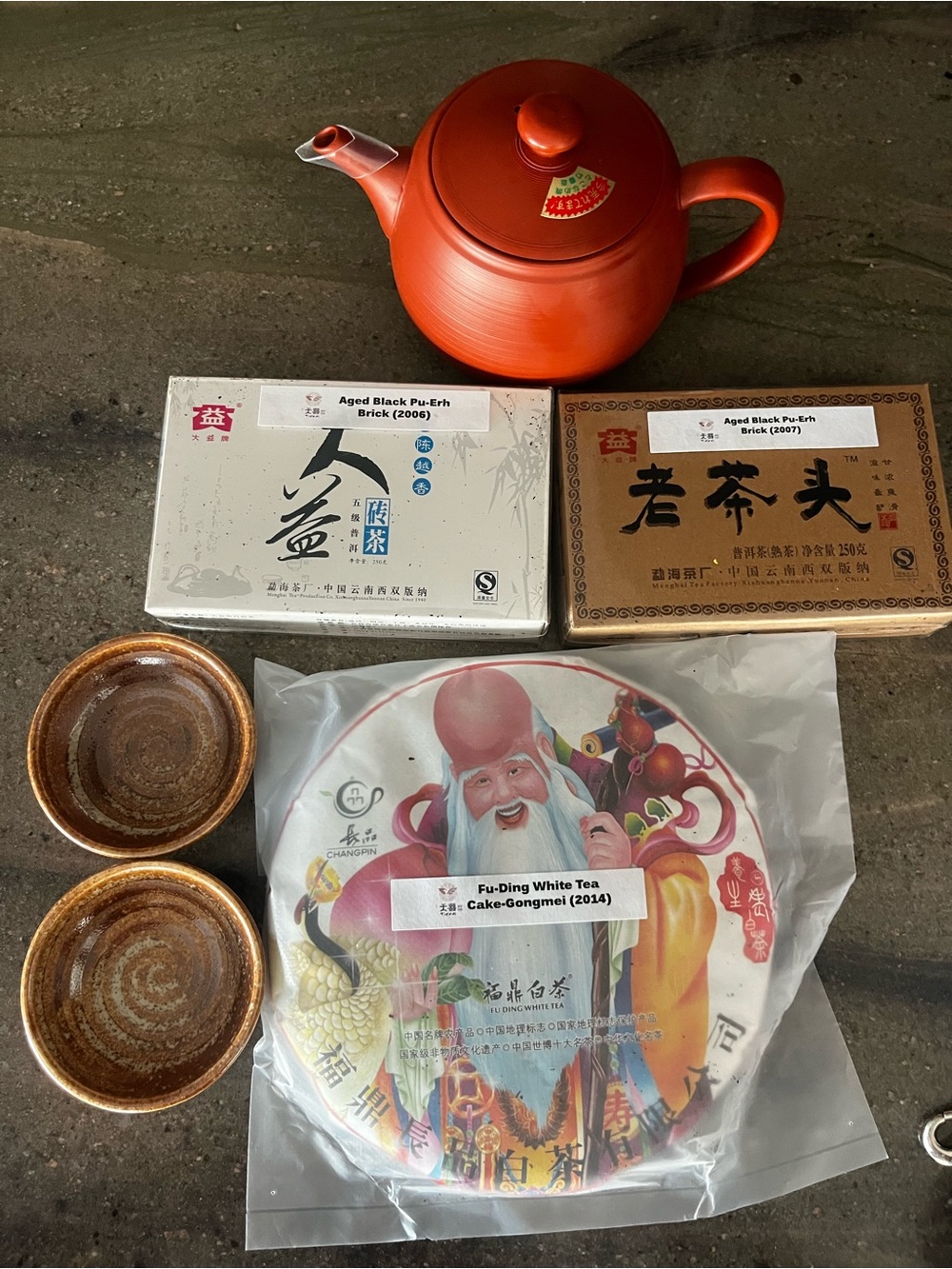 Red Ceramic Teapot with Tea Set and Pu-Erh Tea Cakes